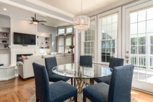 dining table with blue chairs and open to kitchen