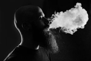 pic of man exhaling smoke