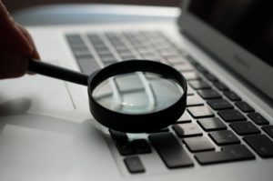 magnifying glass and laptop