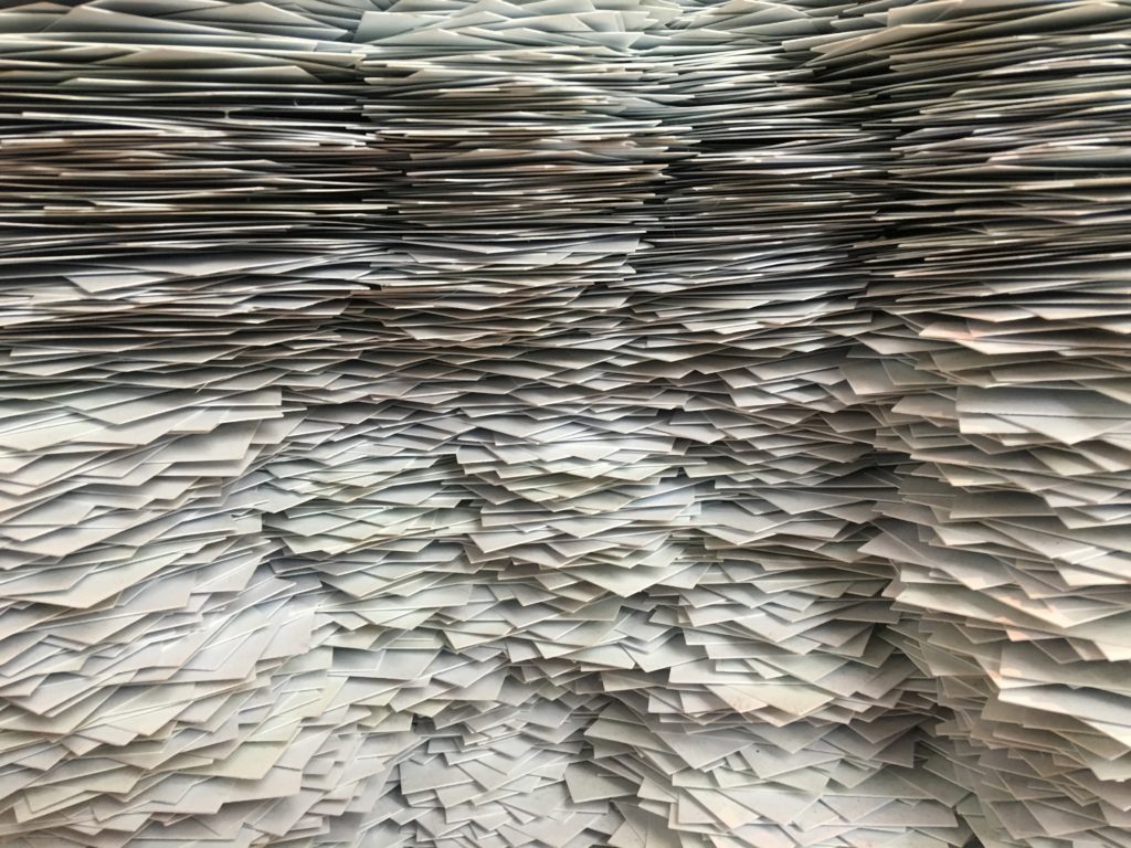 stacks of 1000's of papers in piles