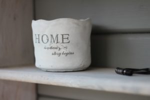 white basket with letters that spell home