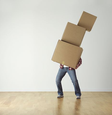 man carrying lots of boxes