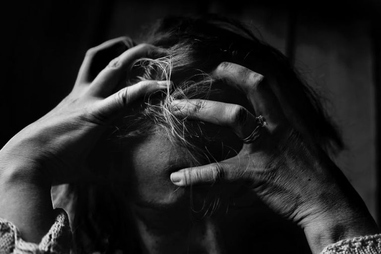 person with head in hand, indicating failure or mistakes